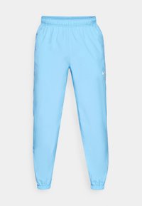 Lichtblauwe joggingsbroek van gladde stof met een elastische tailleband, cuffed enkels en een klein wit Nike-logo aan de zijkant.