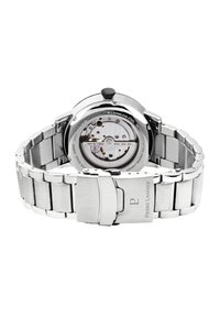 Automatisk klocka i rostfritt stål med en transparent baksida som visar mekaniken. Har ett polerat metallarmband och infällbar spänne.