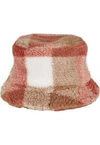 Fuzzy, patchwork bucket hat in shades of pink, brown, and white. Made from soft material with a rounded crown and wide brim.