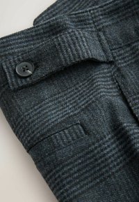Wool plaid trousers in dark grey with blue accents. Features a button closure, flat front, textured fabric, and side pockets.