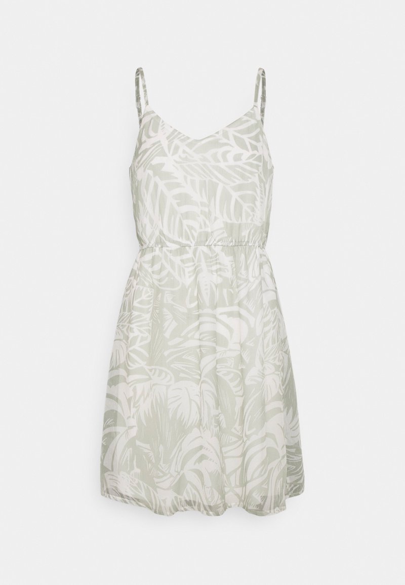 Robe sans manches longueur genou avec taille élastique, fines bretelles et motif feuilles tropicales gris clair sur fond blanc.
