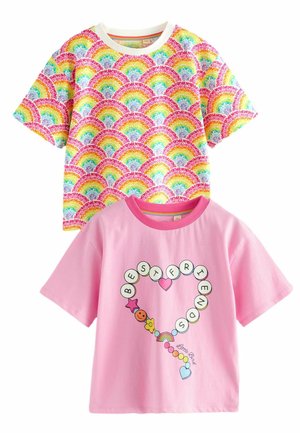 Dos camisetas: una con un patrón de arcoíris multicolor sobre fondo blanco, la otra en rosa con un gráfico de "Mejores Amigos" y acentos coloridos.