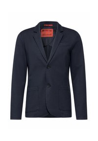 Marinblå kavaj i mjukt tyg med två framfickor, en knappstängning, slagkrage och röd inre etikett.