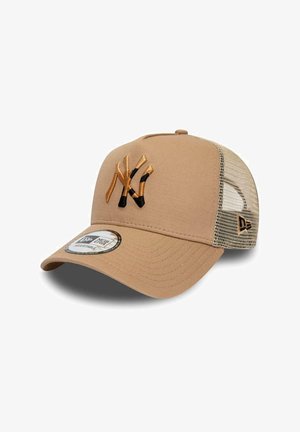 Beige baseball cap with mesh back, adjustable strap, and a stylized "NY" logo embroidered in gold and black on the front panel.