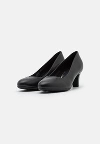 Černé kožené lodičky na vysokém podpatku s rounded špičkou a hladkým povrchem. Podpatky jsou střední výšky a válcového tvaru.
