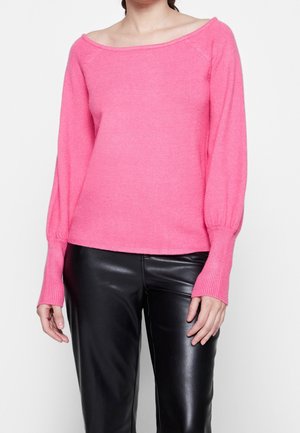 Helles pinkes gestricktes Sweatshirt mit einem schulterfreien Ausschnitt, langen Ballonärmeln und gerippten Bündchen. Getragen mit schwarzen Lederhosen.