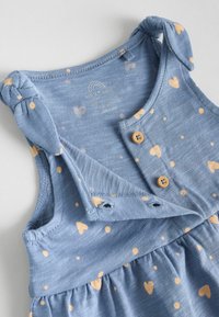 Blue cotton dress featuring small yellow heart and dot patterns, with knotted straps and wooden buttons, gathered waist for a comfortable fit.