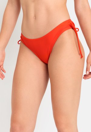 Red bikini bottom with a smooth texture, low-rise design, and adjustable side ties. Features a solid color without patterns or accents.