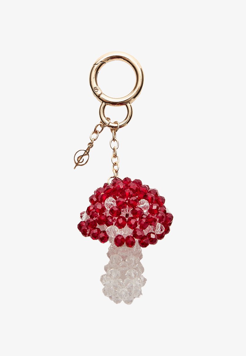 Un porte-clé en perles avec un design de champignon rouge, orné de perles rouges et transparentes facettées, de quincaillerie en métal et d'un fermoir circulaire en ton doré.