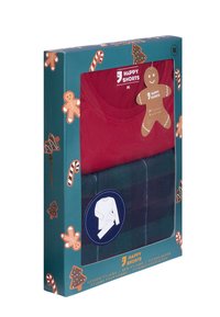 Rode T-shirt en groene geruite shorts verpakt in een feestelijke doos met patronen van peperkoek en zuurstokken; etiket geeft maat M aan.