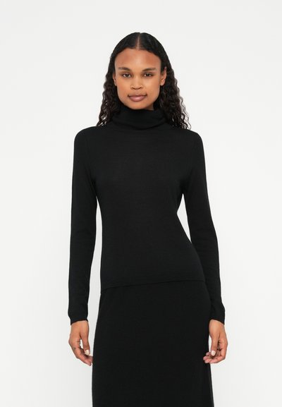 Pull turtleneck noir en jersey doux. Présente des manches longues et une silhouette ajustée, sans motifs ni accents visibles.