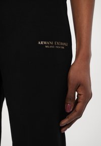 Armani Exchange TROUSER - Donji dijelovi trenirke - black/gold