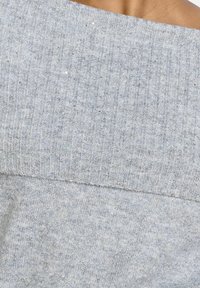 Gray ribbed sweater featuring a wide neckline and soft texture, with subtle sparkling details throughout the fabric.