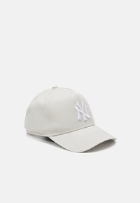 Beige Baseballkappe mit einem weißen gestickten Logo. Verfügt über einen gebogenen Schirm, eine strukturierte Krone und einen verstellbaren Riemen auf der Rückseite.