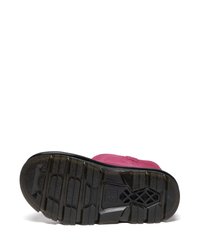 Sapato de camurça rosa com sola de borracha preta texturizada, apresentando sulcos profundos e um logotipo em relevo próximo ao centro para tração e suporte.