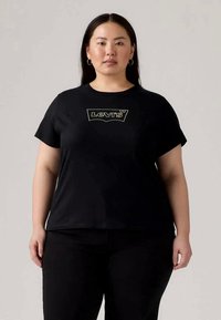 T-shirt de algodão preto com mangas curtas, com um logótipo gráfico em verde claro no peito. Textura suave, corte descontraído e sem padrões.