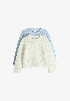 Zwei gestrickte, knöpfbare Strickjacken mit Lochmustern, eine cremefarben vorne und eine hellblau hinten, flach auf einem weißen Hintergrund liegend.