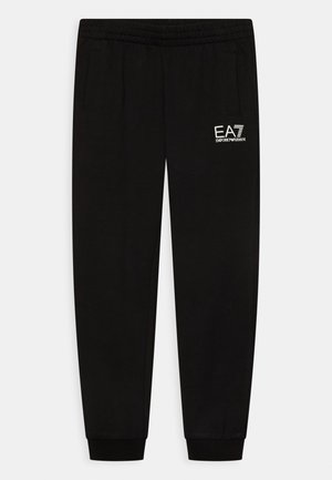 Pantalon de survêtement noir effilé avec ceinture élastique, poches latérales, chevilles resserrées et logo blanc EA7 Emporio Armani sur la cuisse gauche.