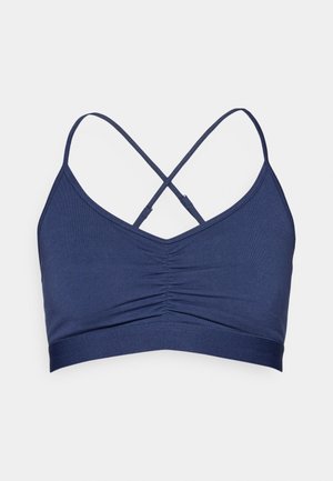 Σκούρο μπλε σουτιέν με ραβδώσεις στο κέντρο, ρυθμιζόμενους λουριάκια που διασταυρώνονται και απαλή υφή. Διαθέτει φαρδύ λάστιχο στο κάτω μέρος.