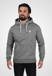 Gray hoodie made of soft fabric, featuring a front pocket, adjustable drawstring hood, and small triangular logo on the chest.