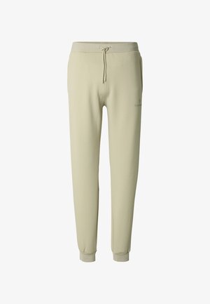 Světlé zelené tepláky s elastickým pasem, stahovací šňůrkou a žebrovanými manžetami; vyrobené z měkké látky s hladkým povrchem.