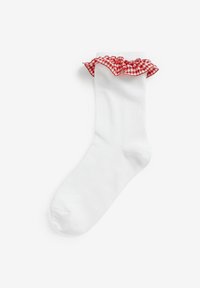 Weißer Baumwollsocken mit einem gefransten oberen Ende, das ein rotes und weißes Vichymuster aufweist. Glatte Textur mit einer runden Zehenpartie und knöchellang.