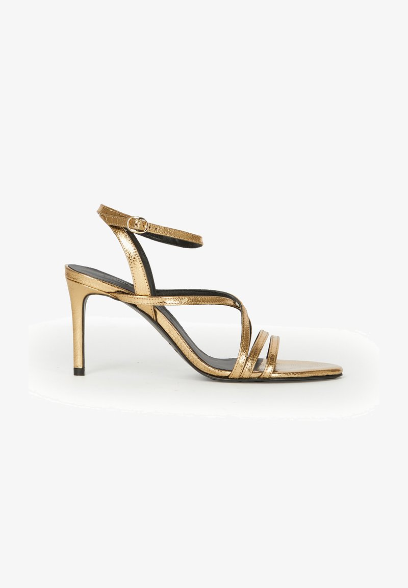 Gold metallic high-heeled sandal with thin ankle strap, open toe, and slim multi-strap design on a white background.