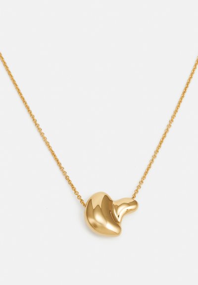 Gold-colored necklace featuring a smooth, organic-shaped pendant on a fine chain, highlighting a polished finish without intricate details.