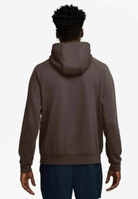 Brown hooded sweatshirt made of soft fabric, featuring a relaxed fit, ribbed cuffs, and a kangaroo pocket. Back view shown.