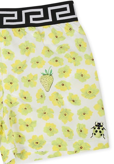 Pantaloni corti da uomo in tessuto leggero con una base bianca, decorati con fiori gialli, un design a fragole con pois verdi e una cintura a fantasia nera.
