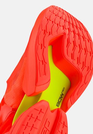 Bright orange athletic shoe sole with hexagonal pattern and yellow insole labeled BOWTECH, shown from the bottom and side angle.