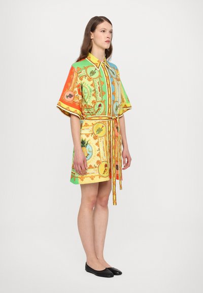 Colorful short-sleeve shirt dress with a collar, featuring a vibrant pattern of fruits and designs, cinched at the waist with a matching tie.