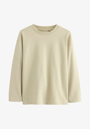 Lys beige langærmet T-shirt med rund halsudskæring og en blød, glat tekstur. Har dropped shoulders og en afslappet pasform.