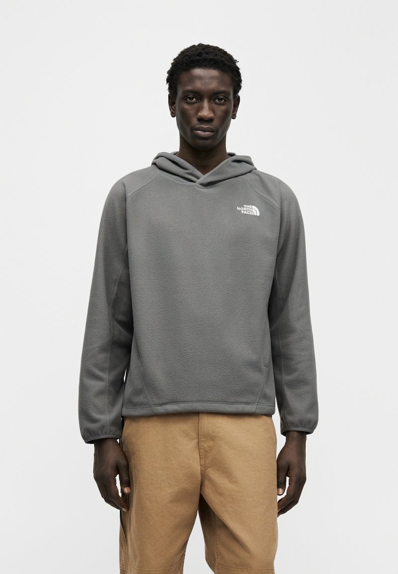 Gray fleece pullover hoodie with a cowl neck, featuring a white logo on the left chest and long sleeves, paired with tan cargo shorts.