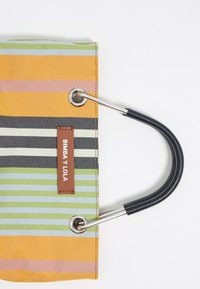 Striped tote bag with orange, green, pink, and black stripes. Features a brown leather label and silver hardware with black handles.