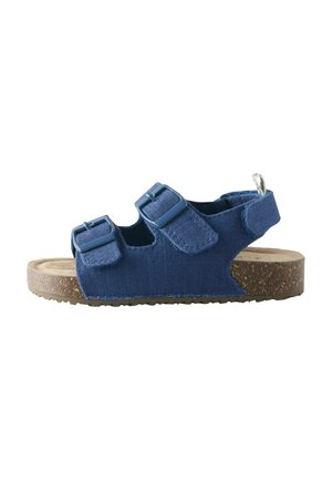 Blue fabric sandal with two adjustable buckle straps, a back strap with Velcro, and a cork sole.