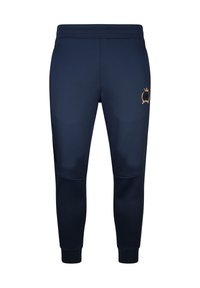 Pantalon de survêtement bleu marine fuselé avec taille et poignets élastiques, présentant un petit emblème doré sur la partie supérieure de la cuisse gauche.