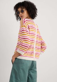 Striped sweater with pink, orange, and yellow stripes on a white background; features a button closure at the back and loose-fitting sleeves.