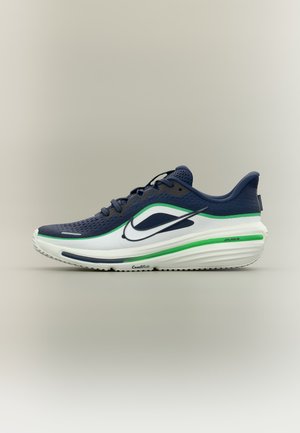 Chaussure de course bleu marine avec semelle verte et blanche, logo Nike Swoosh noir et blanc, et semelle intermédiaire ComfiRide rembourrée, vue de côté.