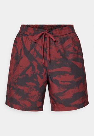 Pantaloni corti con motivo rosso e nero realizzati in tessuto leggero, con vita elastica e cordoncino regolabile.