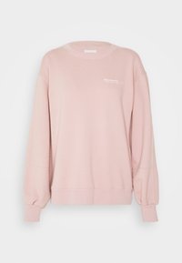 Jasnoróżowa bluza z miękkiego materiału, z okrągłym dekoltem, balonowymi rękawami i subtelnym logo z przodu.