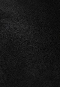 Material textil negru cu o suprafață moale și texturată. Materialul pare mat, fără modele sau accente vizibile.
