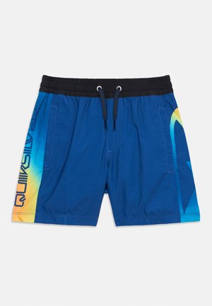 Șort de baie albastru cu talie elastică neagră, șnururi, buzunare laterale și logo Quiksilver în degrade de la galben la albastru pe părți.