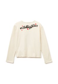 Camicia a maniche lunghe color crema con taglio corto, che presenta "the Rolling Stones" in paillettes nere e accenti rossi a forma di stella sul retro.