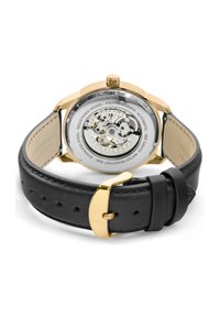 Montre automatique avec un fond de boîtier transparent, un cadran en acier inoxydable doré, un bracelet en cuir noir et des détails de mouvement en argent complexes.