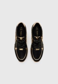 Black and gold athletic shoes with a textured upper, zipper detail, and lace closure. Size 37 marked inside the shoe.