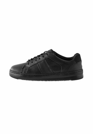Baskets noires à lacets en cuir texturé, offrant un design épuré, une semelle en caoutchouc et des accents minimalistes pour un look moderne.