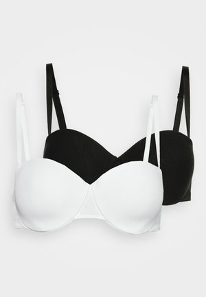 Δύο μαξιλαρωτά σουτιέν, ένα σε λευκό και ένα σε μαύρο. Απαλή υφή, στήριξη με μπανέλα, ρυθμιζόμενες τιράντες και αόρατος σχεδιασμός.