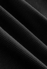 Black ribbed fabric with prominent vertical grooves. Smooth texture with a soft finish, showcasing a slight sheen under light.