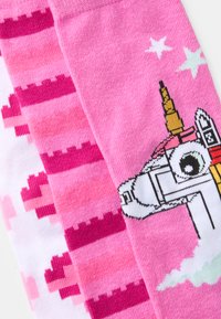 Pink patterned socks featuring a unicorn graphic alongside gradient stripes in varying shades of pink and white. Soft texture, knit material.